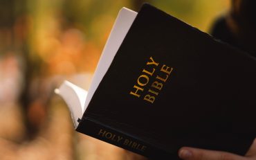 Christian teen girl holds bible in her hands. Reading the Holy Bible. Concept for faith
